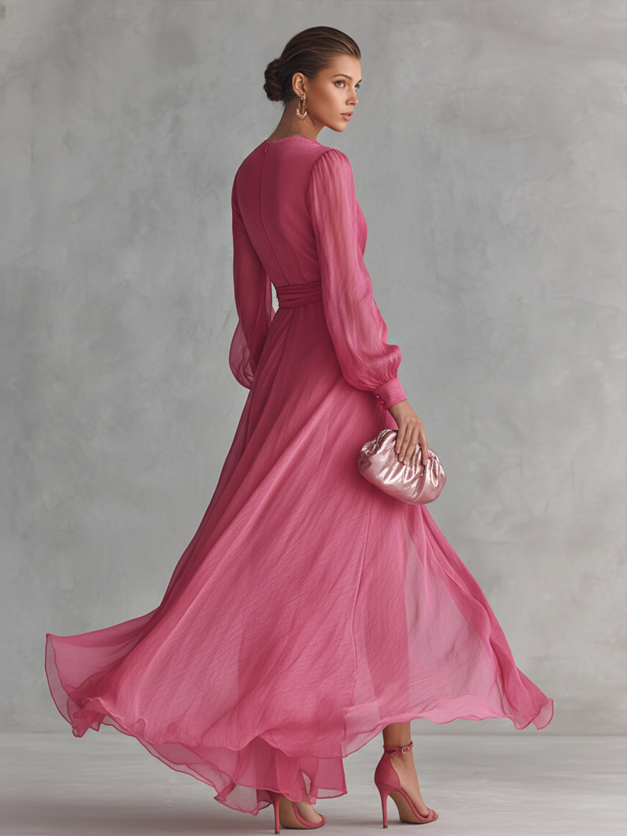 Women's elegant pink occasion wear maxi dress with long sleeves, plunging neckline, and stylish tie-waist detail.