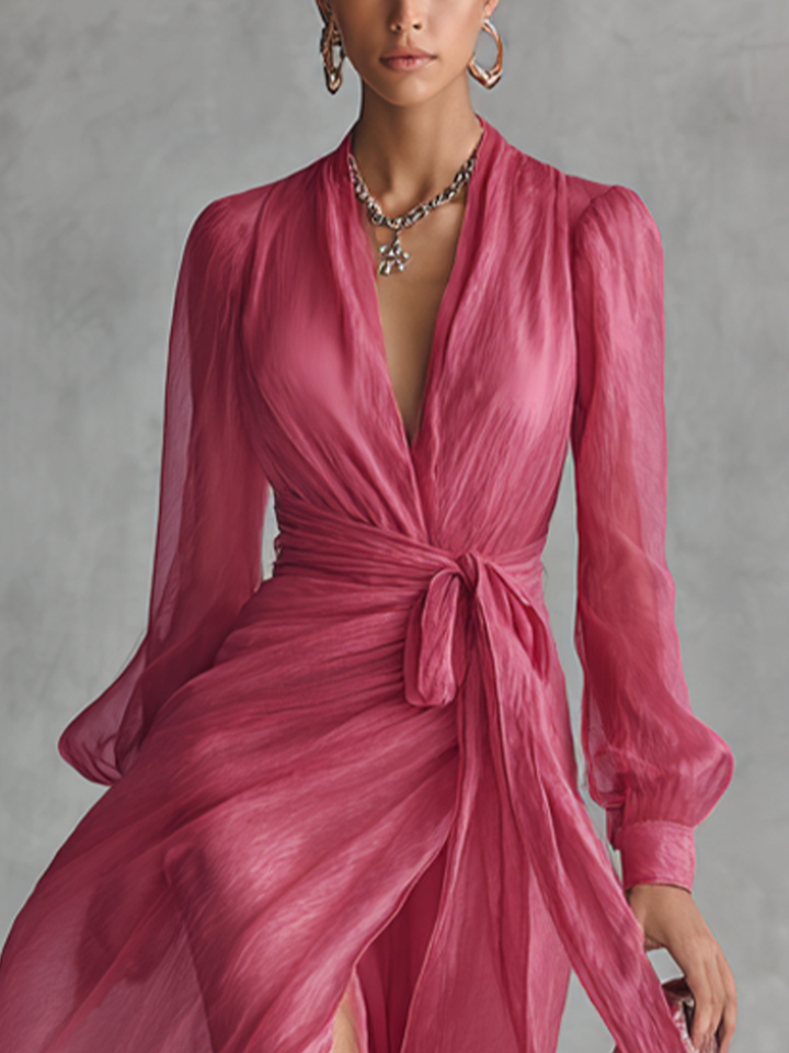 Stylish women's pink party maxi dress with a deep plunging V-neck, long sleeves, and elegant floor-length silhouette.