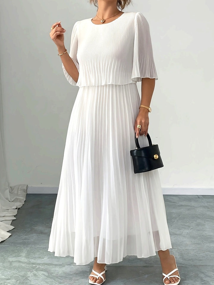 Elegant women's pleated A-line maxi dress for wedding guests. Formal white evening gown, occasion wear.