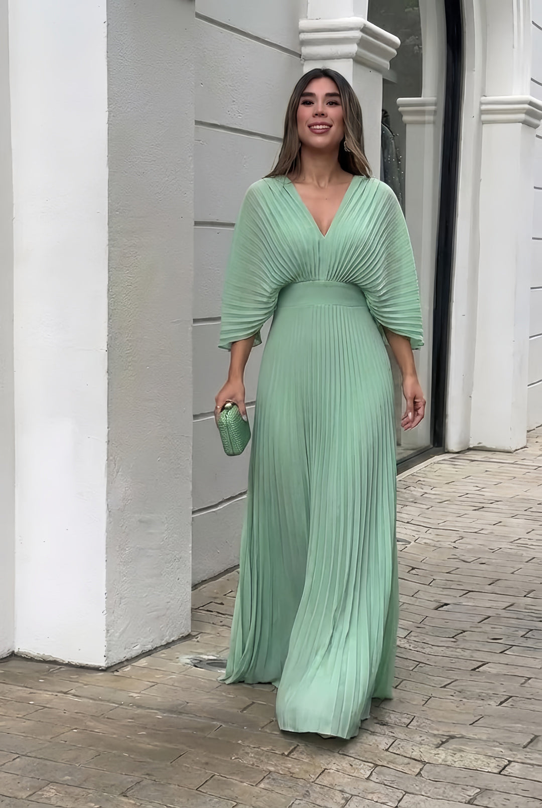 Chic women's long pleated dress, an elegant maxi evening gown with distinct kimono sleeves and a V-neck cut.