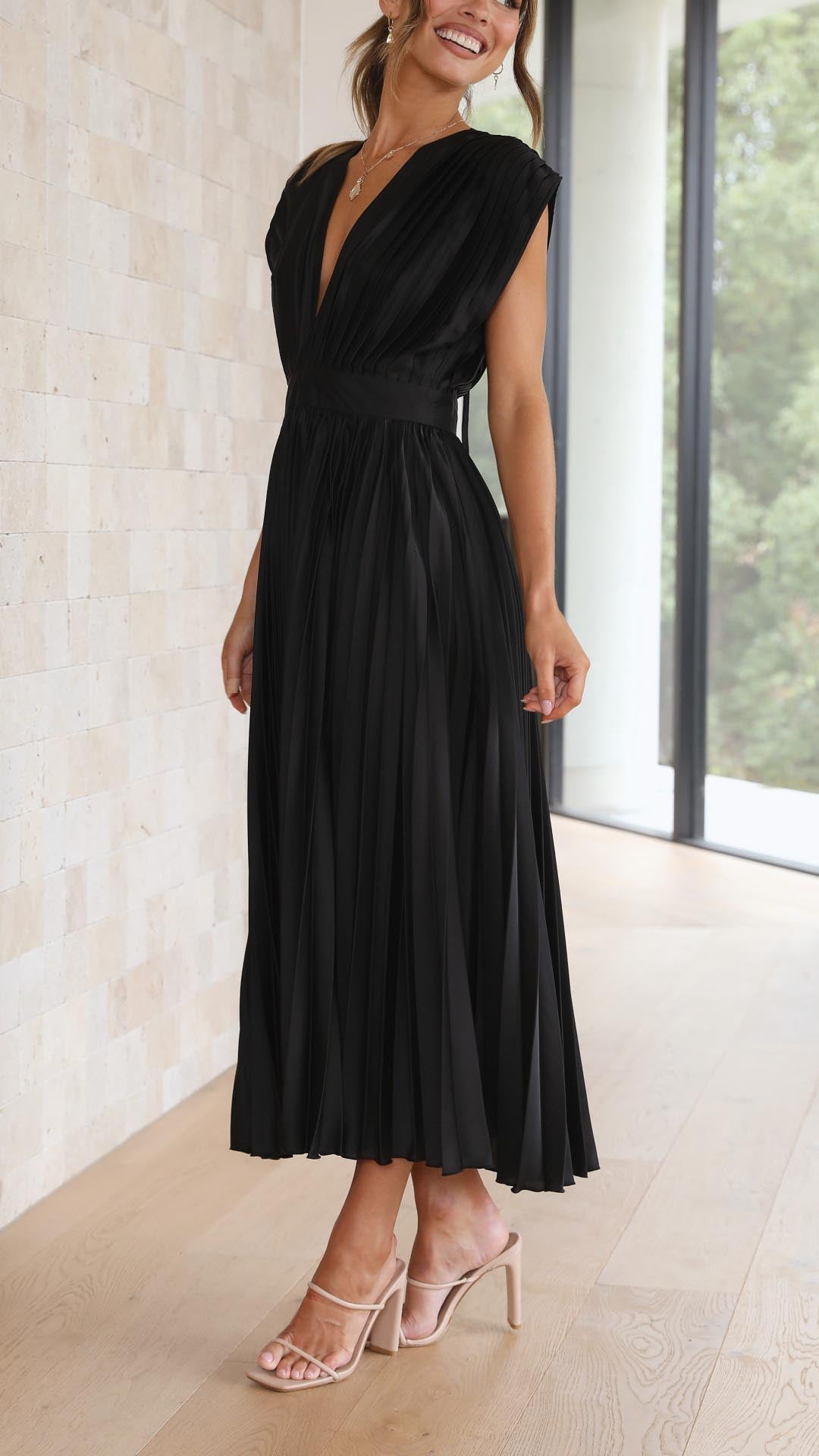 Graceful women's flowing dress with elegant pleats, a chic maxi style for formal or casual.