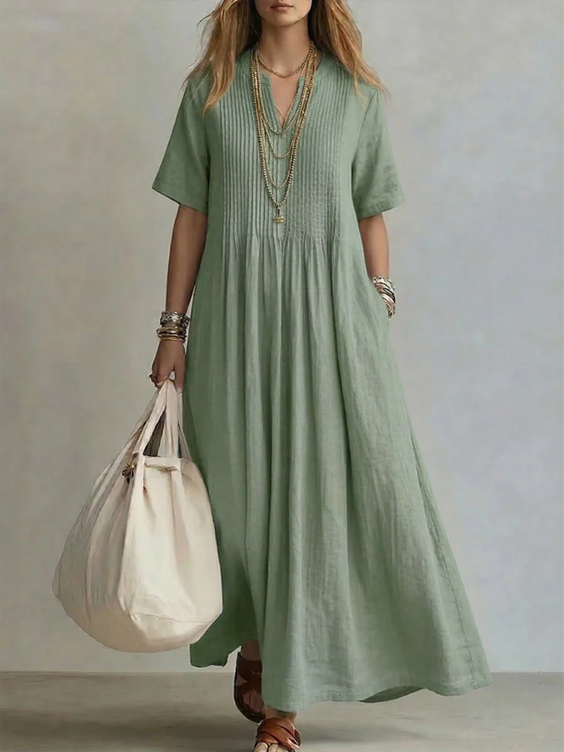 Comfortable women's pleated maxi dress with V-neck and pockets. Elegant, flowy, and relaxed fit for summer casual wear.