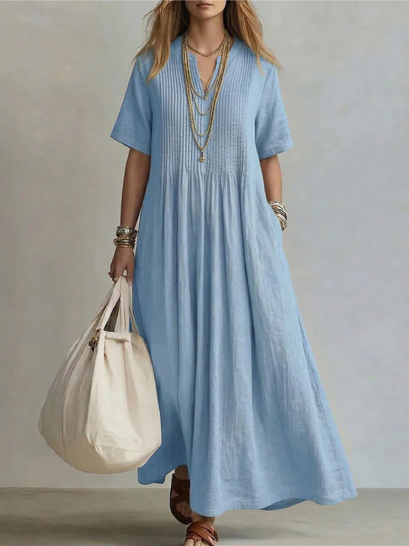 Flowy women's V-neck pleated maxi dress, perfect for elegant summer fashion or casual wear. Features a relaxed fit and pockets.