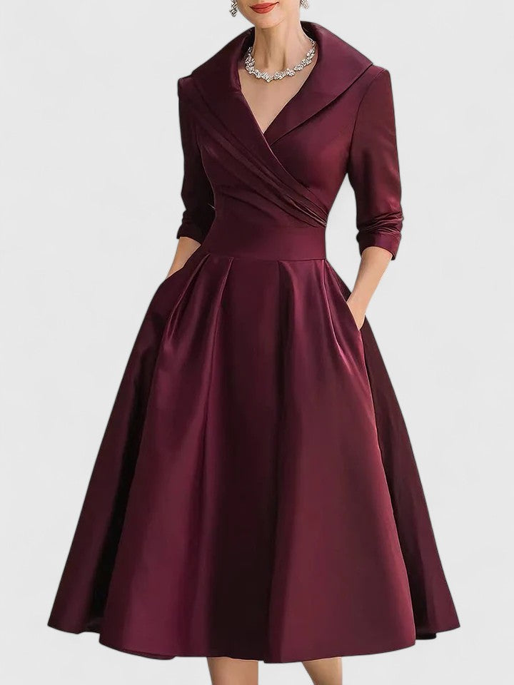Modest women's midi dress with a sophisticated wrap bodice and elegant pleats, perfect for formal wear or summer holidays.