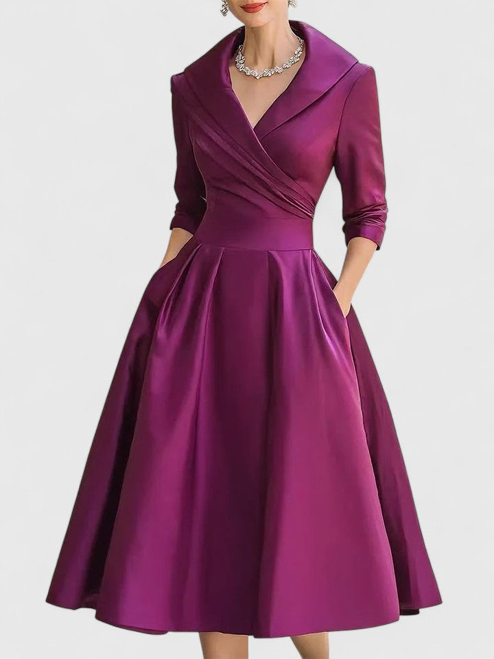 Detail of the elegant wrap bodice and delicate pleats on this women's modest midi dress, suitable for any occasion.
