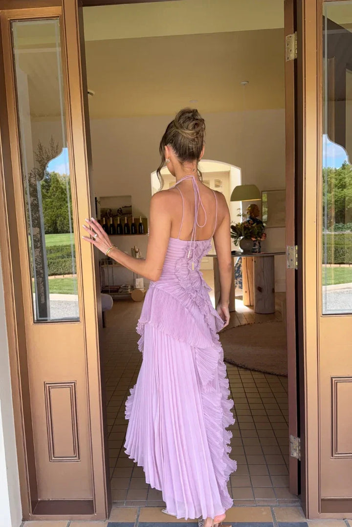 Women's elegant maxi dress featuring pleats and ruffles, suitable for a wedding guest.