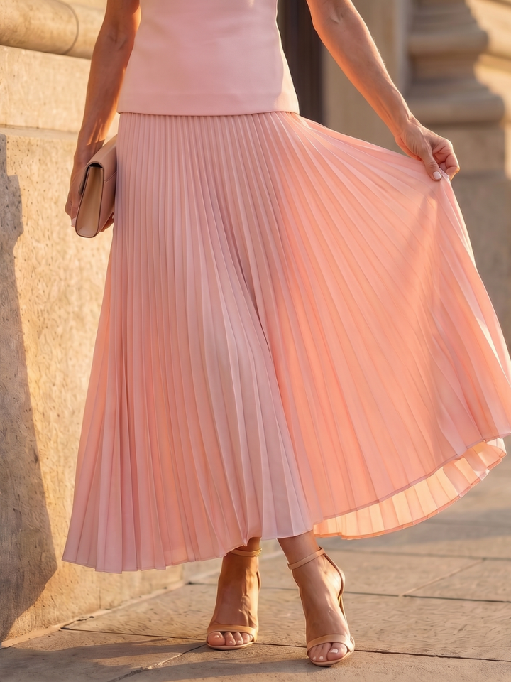 Sleeveless structured top & elegant pleated midi skirt women's two-piece set. Modern women's fashion.