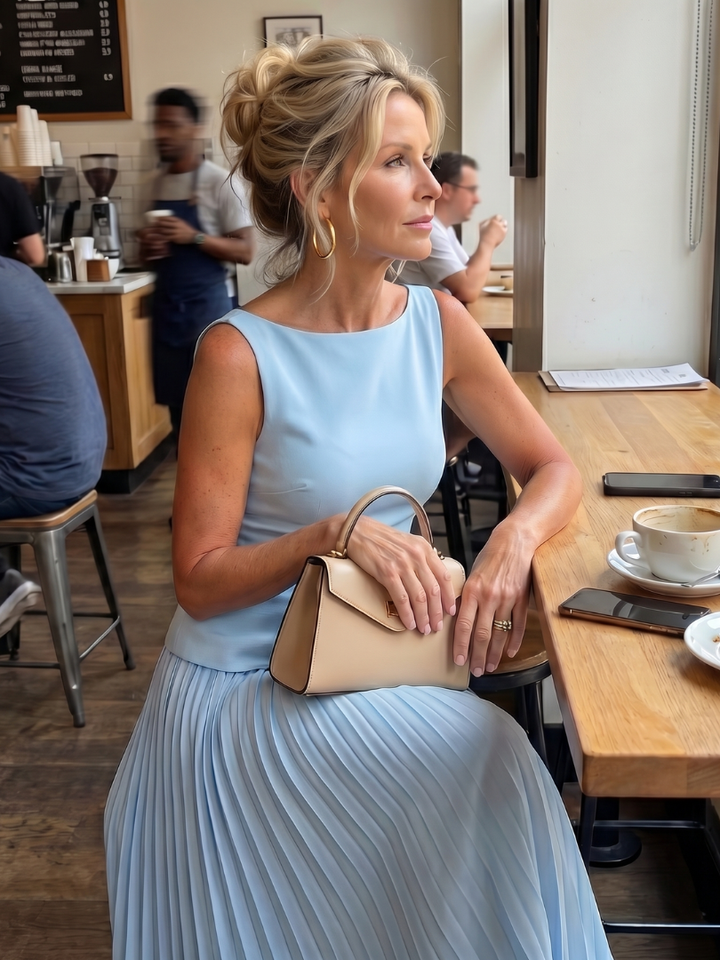 Elegant women's set for events: structured sleeveless top with a beautiful pleated midi skirt. Formal fashion.