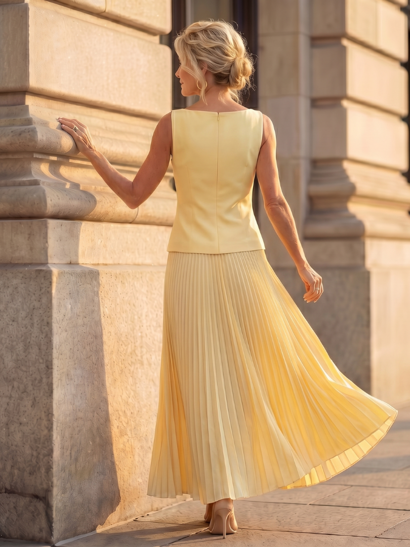 Summer style women's two-piece: elegant structured top and airy pleated midi skirt. Casual chic look.