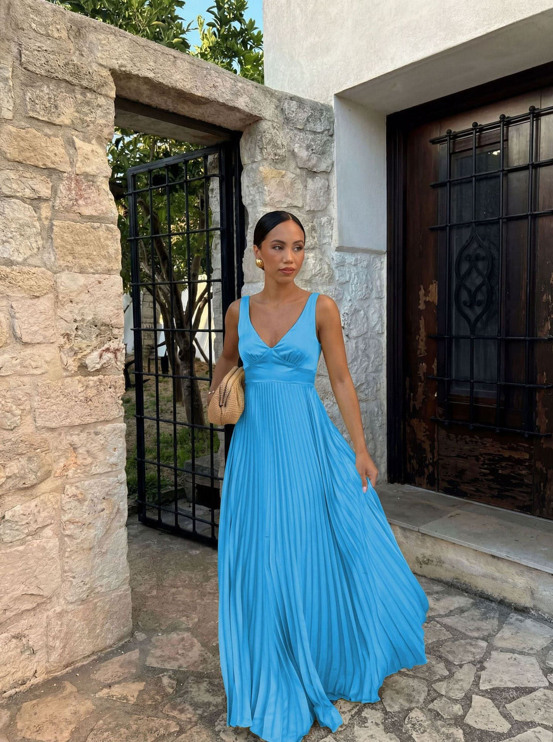 Beautiful pleated V-neck women's maxi dress, an elegant sleeveless formal gown for special occasions.