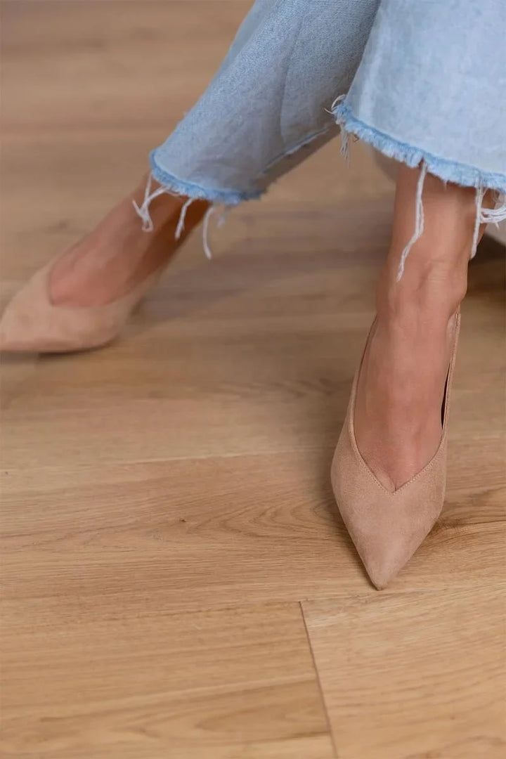 Classic women's pointed-toe slingback pumps with a high stiletto heel. Sophisticated and versatile evening wear heels.