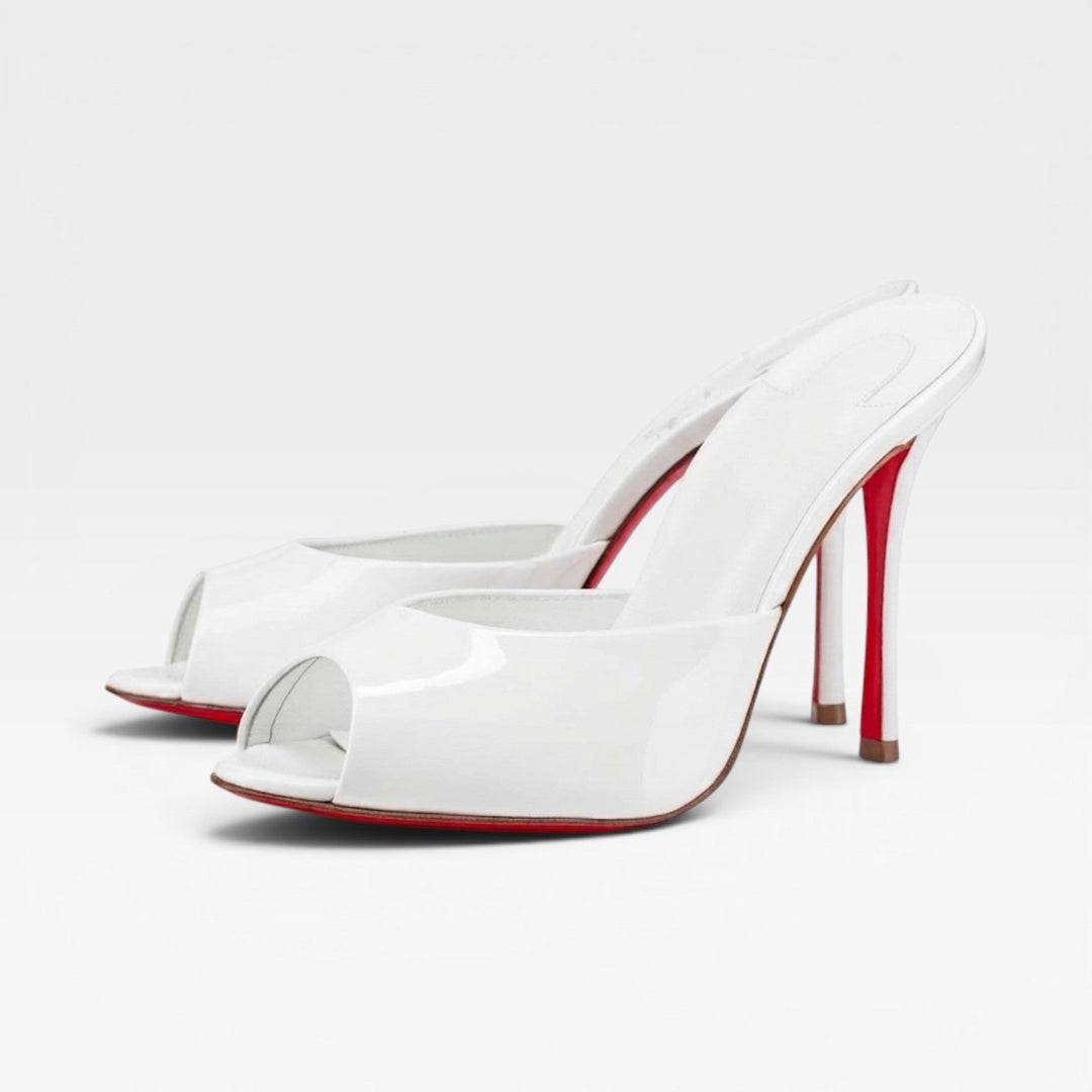 Chic white pointed toe slip-on mules for women, perfect bridal and party shoes with a stiletto heel.