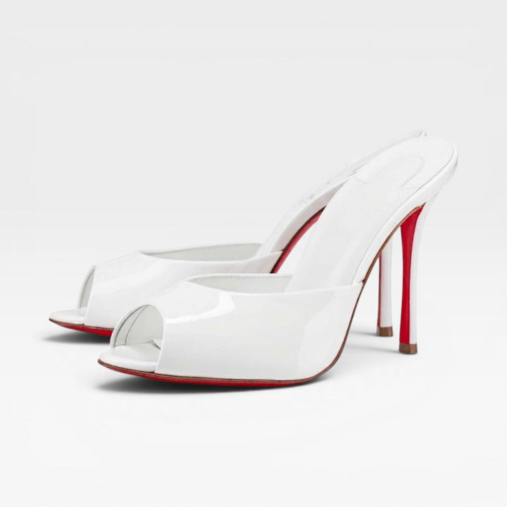 Chic white pointed toe slip-on mules for women, perfect bridal and party shoes with a stiletto heel.