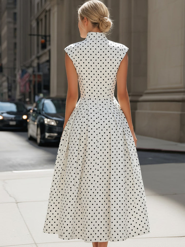 Classic women's A-line midi dress with polka dots, sleeveless design, elegant choice for summer and occasion wear.