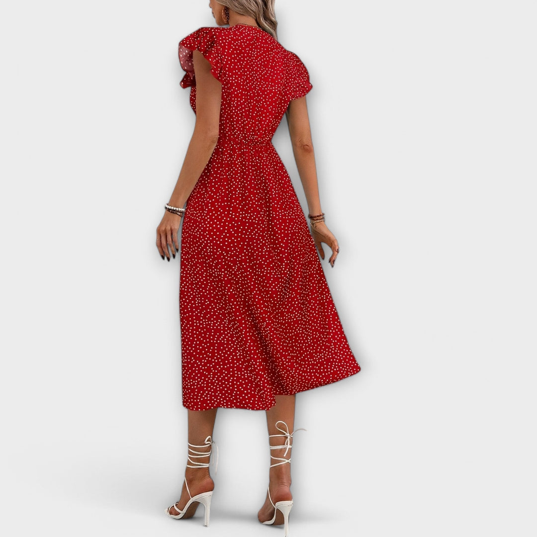 Side view of an elegant women's polka dot A-line midi dress, flattering fit for any spring/summer event.