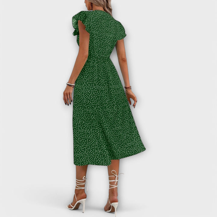Back view of a women's elegant polka dot A-line midi dress, stylish and comfortable for casual wear.