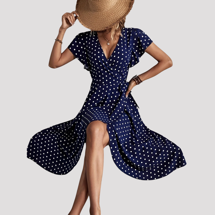 Elegant women's polka dot wrap midi dress with V-neck, flutter sleeves, and tie-waist. Perfect for summer fashion.