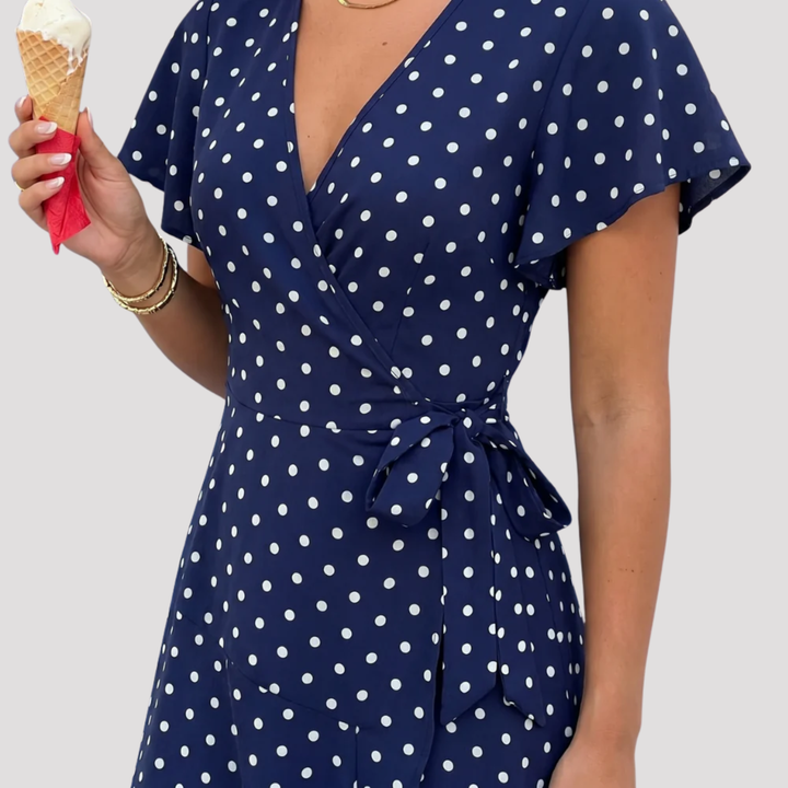 Elegant women's V-neck wrap midi dress with polka dot pattern, flutter sleeves & tie-waist. Great for summer events.