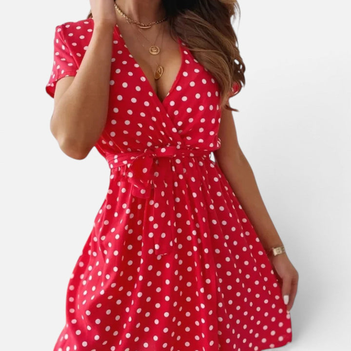 Elegant women's polka dot wrap mini dress with short sleeves, perfect for smart casual or day wear.