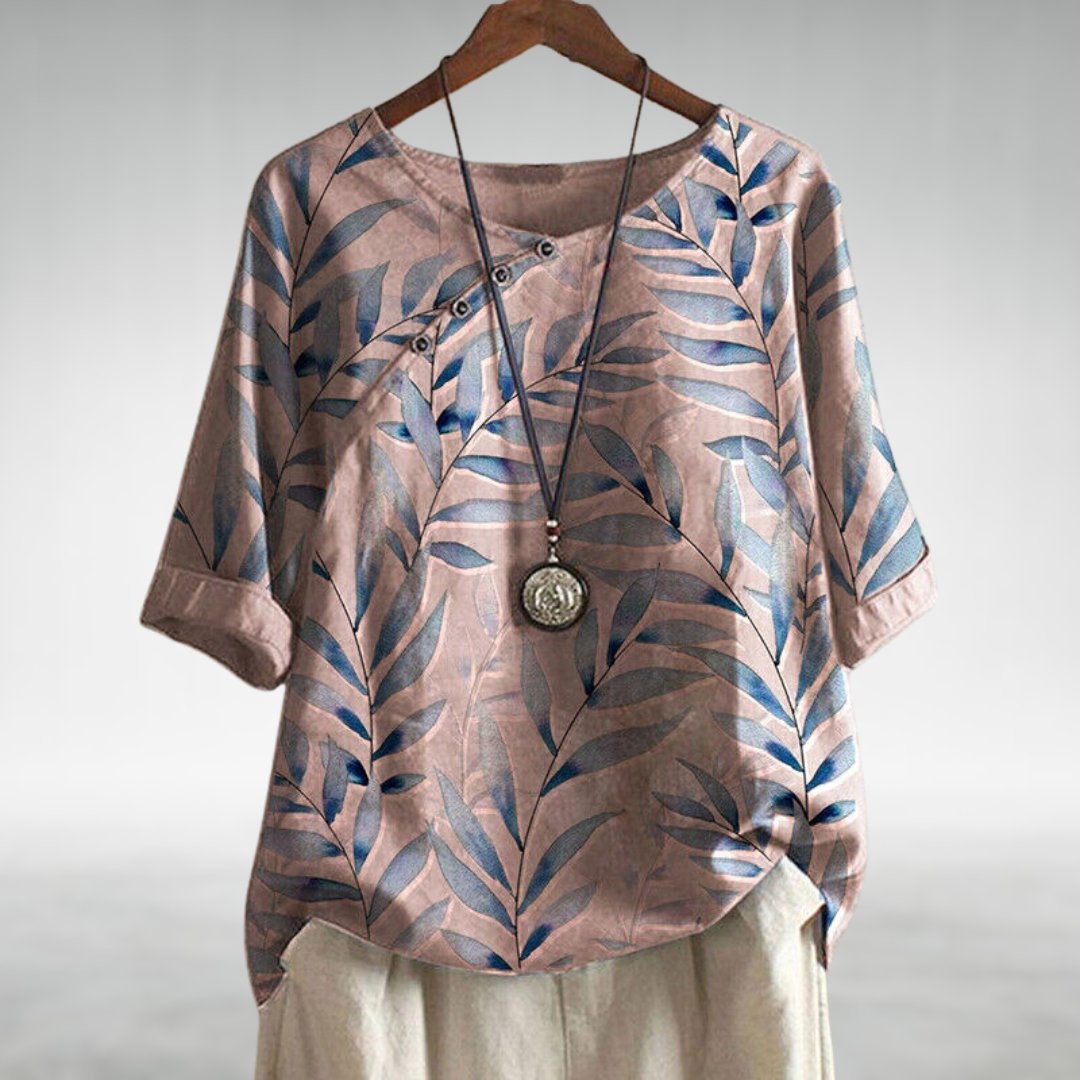 Comfortable women's printed 3/4 sleeve top, versatile for work or casual wear. Fashionable round neck blouse.