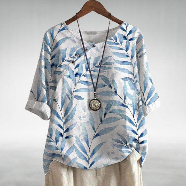 Chic women's printed blouse featuring a unique pattern, 3/4 sleeves, and a flattering round neck for a stylish look.