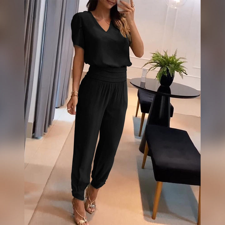 Elegant women's printed jumpsuit with a flattering V-neck, wide legs, and adjustable tie waist for a relaxed fit.