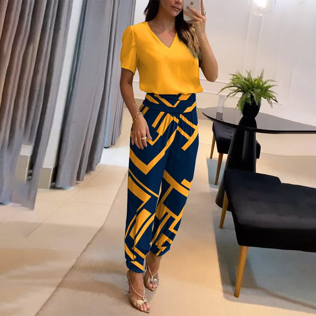 V-neck wide-leg printed jumpsuit for women with a stylish tie waist. Perfect for elegant, casual summer fashion.