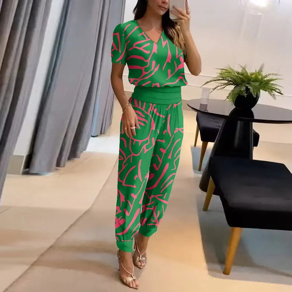 Vibrant printed women's jumpsuit with a flattering V-neck, comfortable wide legs, and an adjustable tie waist.