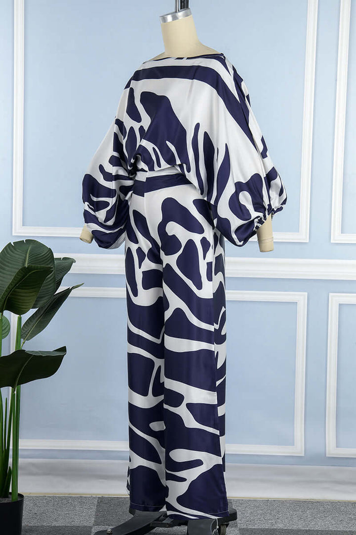 Modern women's two-piece set: printed off-shoulder long sleeve top with an elegant matching skirt.