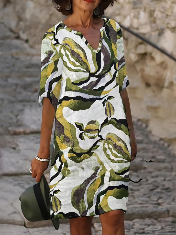 Elegant women's printed summer dress, knee-length, flowy, perfect for casual daywear or vacation.