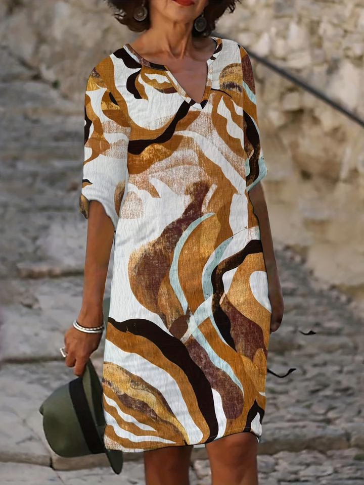 Flowy, comfortable women's printed summer dress with vibrant colors, suitable for elegant casual wear.