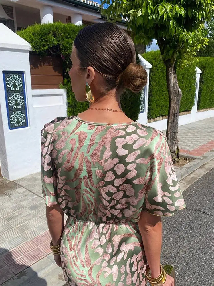 Chic women's occasion wear: a beautiful printed midi dress featuring an elegant twist-front design.