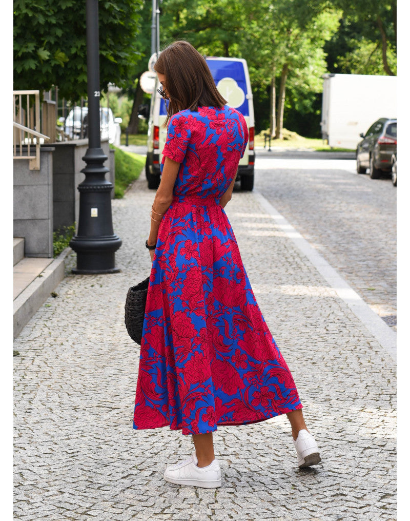 Flattering printed women's mid-calf wrap dress. Features a V-neck, short sleeves, and tie waist for an elegant silhouette.