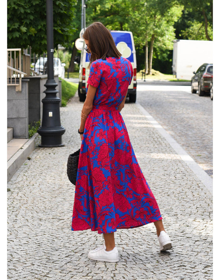 Flattering printed women's mid-calf wrap dress. Features a V-neck, short sleeves, and tie waist for an elegant silhouette.