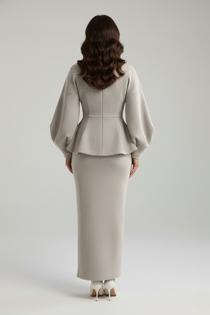 Formal women's two-piece skirt suit set featuring a puff sleeve blazer and matching midi skirt.