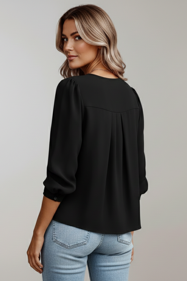 Stylish women's round neck blouse with elegant puff sleeves and flattering pleated details.