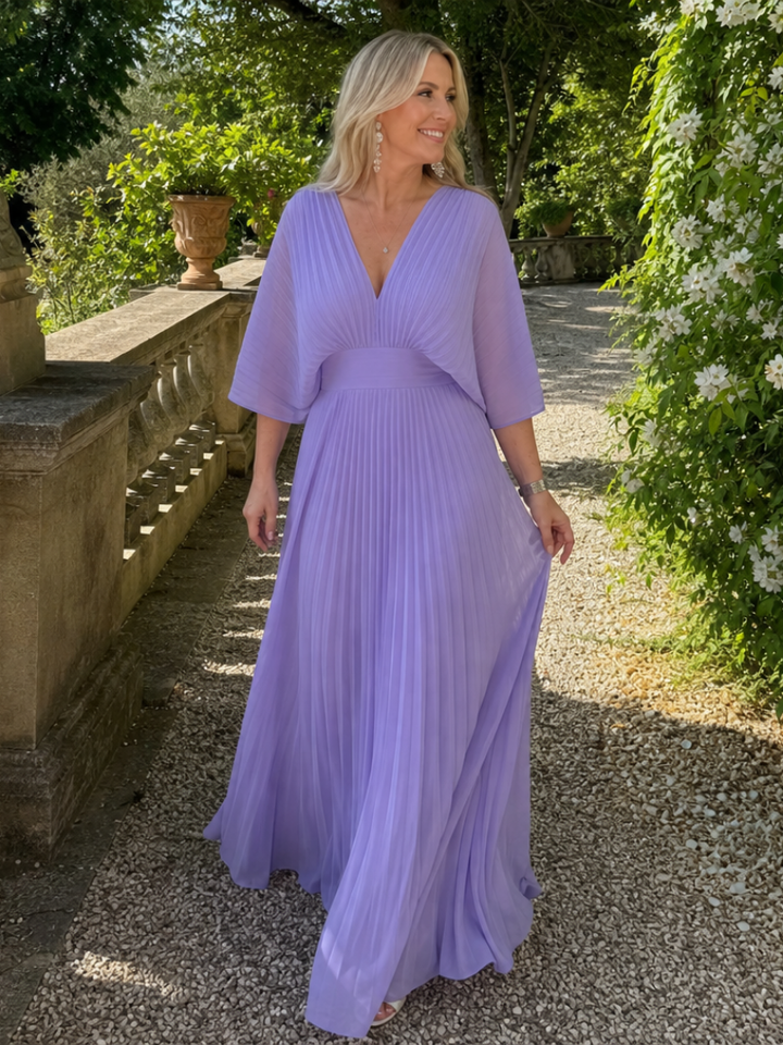 Women's elegant V-neck maxi dress with long sleeves & beautiful pleats, a sophisticated party dress.