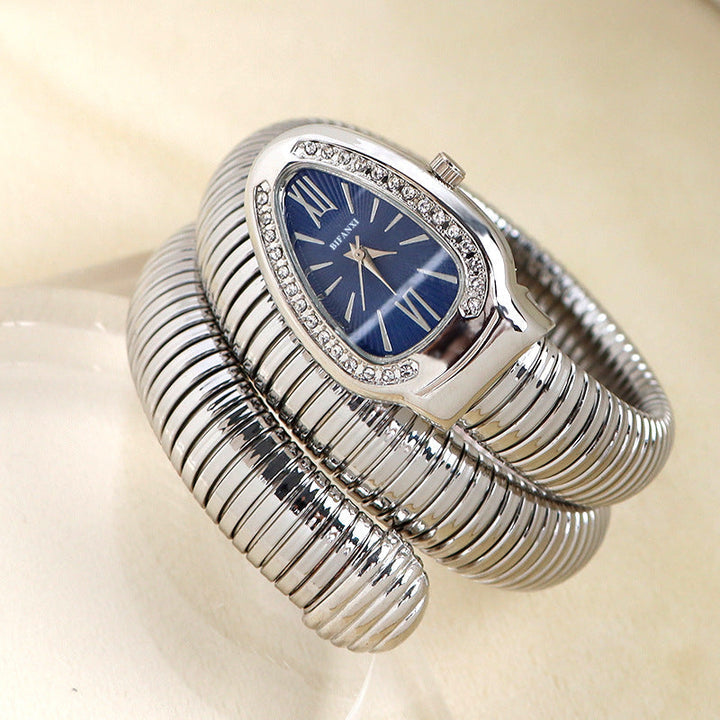 Stylish silver-tone women's quartz watch, snake-inspired bracelet, fashion forward.