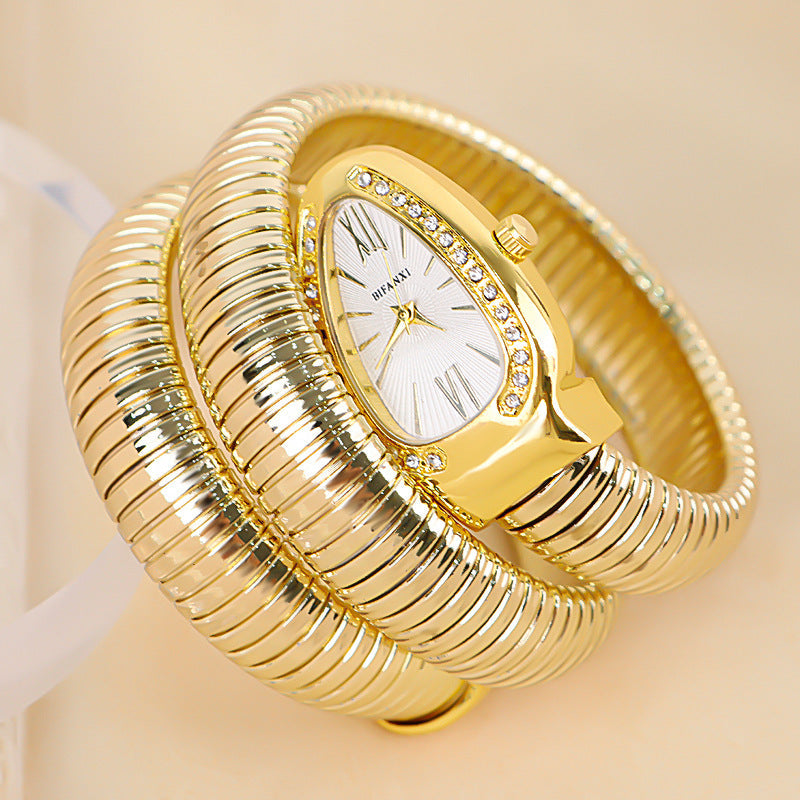 Gold-tone women's snake coil bracelet watch, quartz movement, a glamorous accessory.