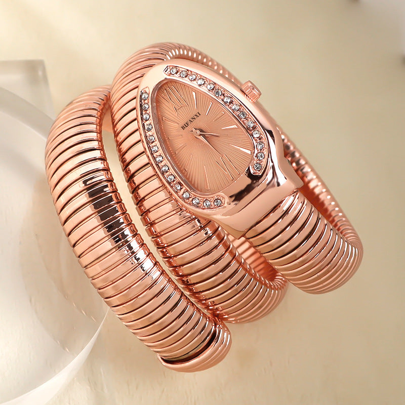 Fashionable women's quartz watch, silver-tone snake bracelet, adds a unique touch.