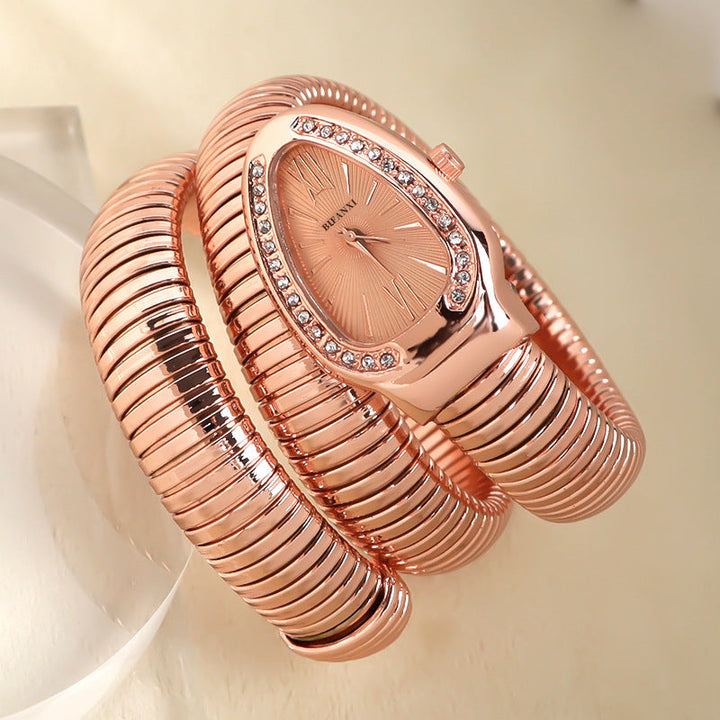 Fashionable women's quartz watch, silver-tone snake bracelet, adds a unique touch.