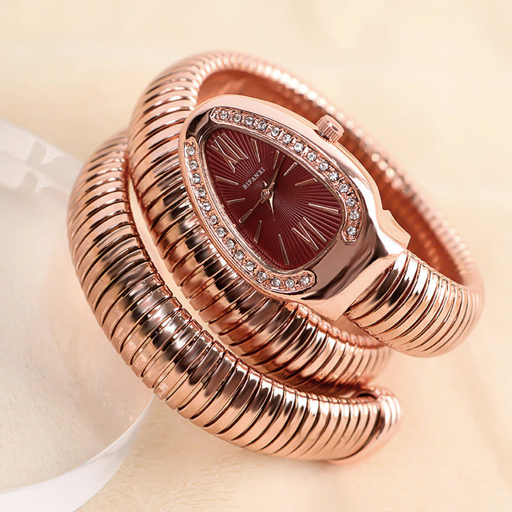 Gold-tone women's elegant snake bracelet quartz watch, a sophisticated fashion item.