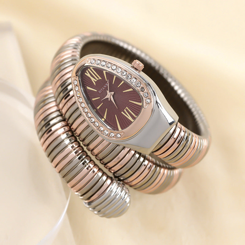 Women's fashion quartz watch with a coiled snake bracelet in silver tone.