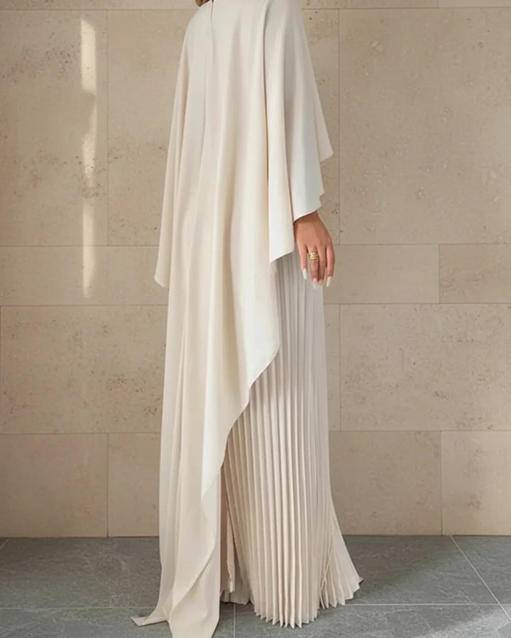 Chic women's beige pleated cape maxi dress, a sophisticated choice for wedding guest attire.