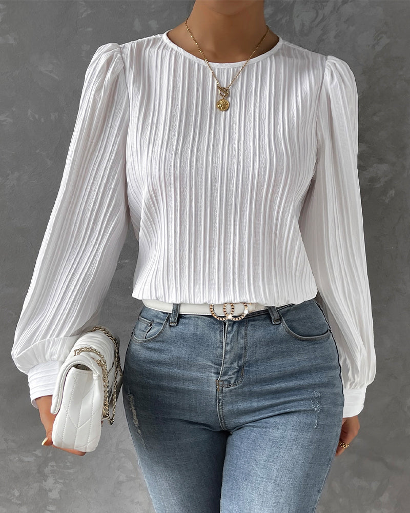 Modern women's round neck blouse, long sleeves. Essential fashion top for an elegant, casual chic look.