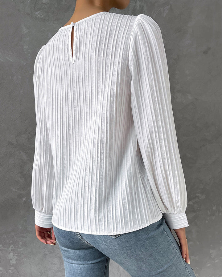 Women's elegant long sleeve round neck blouse. A versatile fashion top suitable for work and everyday style.