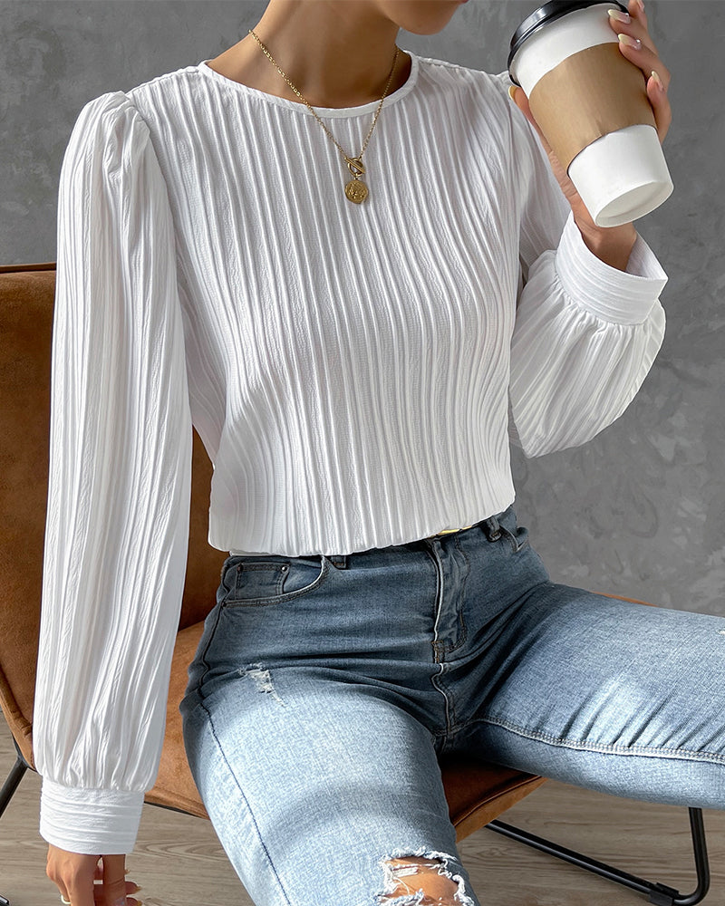 Fashionable women's round neck top with long sleeves. An elegant blouse for casual or professional attire.