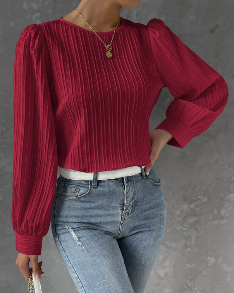 Versatile women's round neck blouse. Long sleeve design for elegant work wear or smart casual outfits.