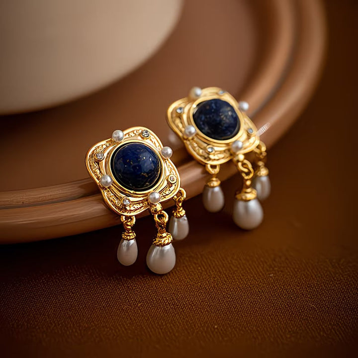 Luxurious women's royal blue pearl chandelier drop earrings, ideal for an elegant evening or fashion statement.