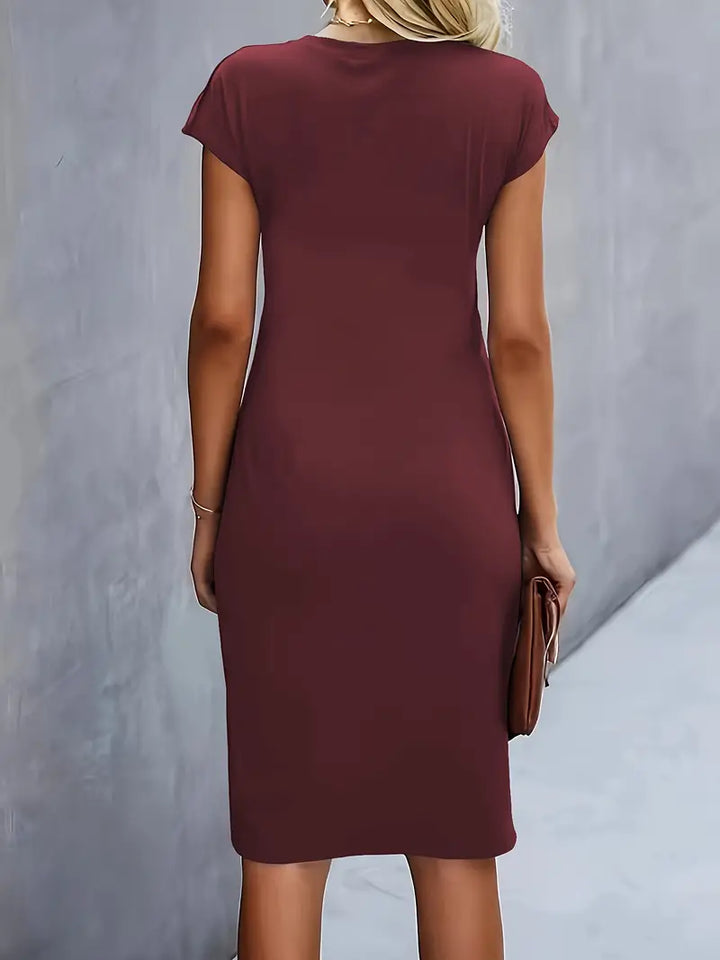 Elegant knee-length sheath dress, women's, with flattering ruched and cap sleeves.